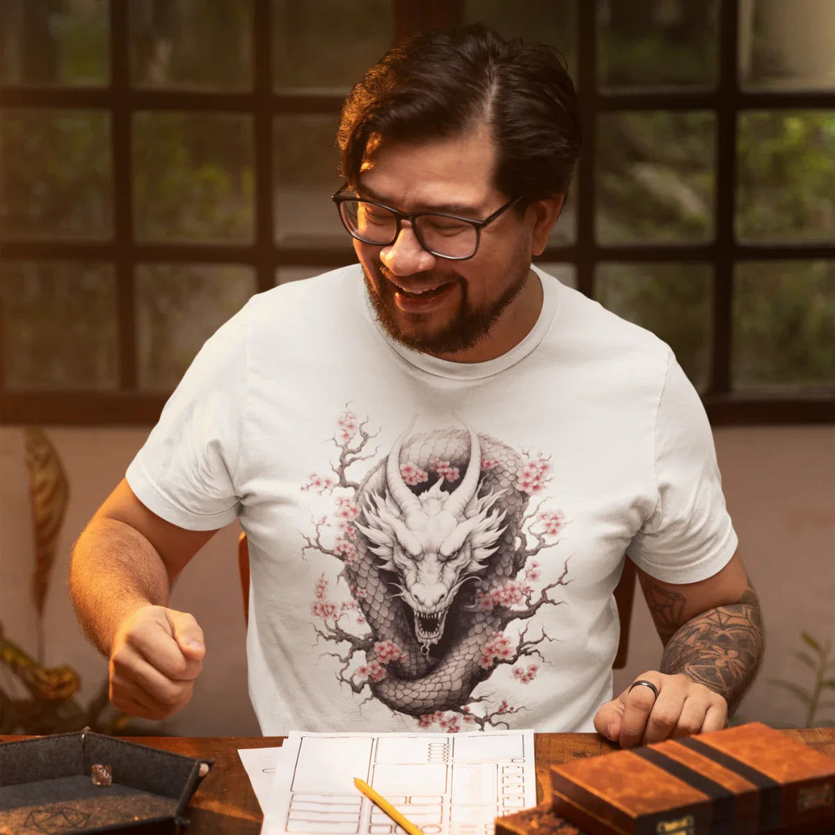 A man with a beard and glasses is wearing a shirt with a flowery dragon print and is currently rolling dice.