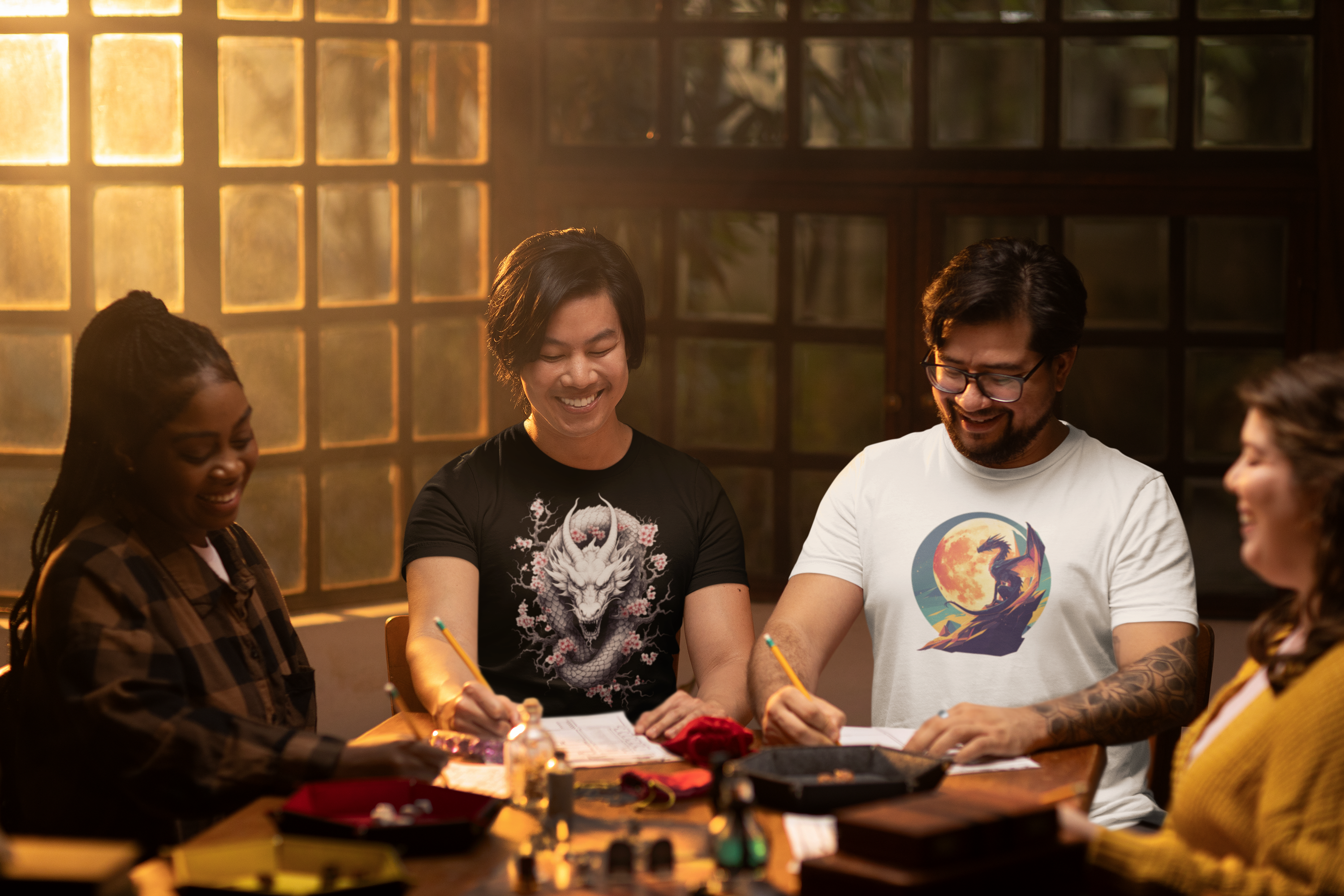 A group of friends sit happily together at the games table wearing t-shirts with colourful dragon motifs on them.