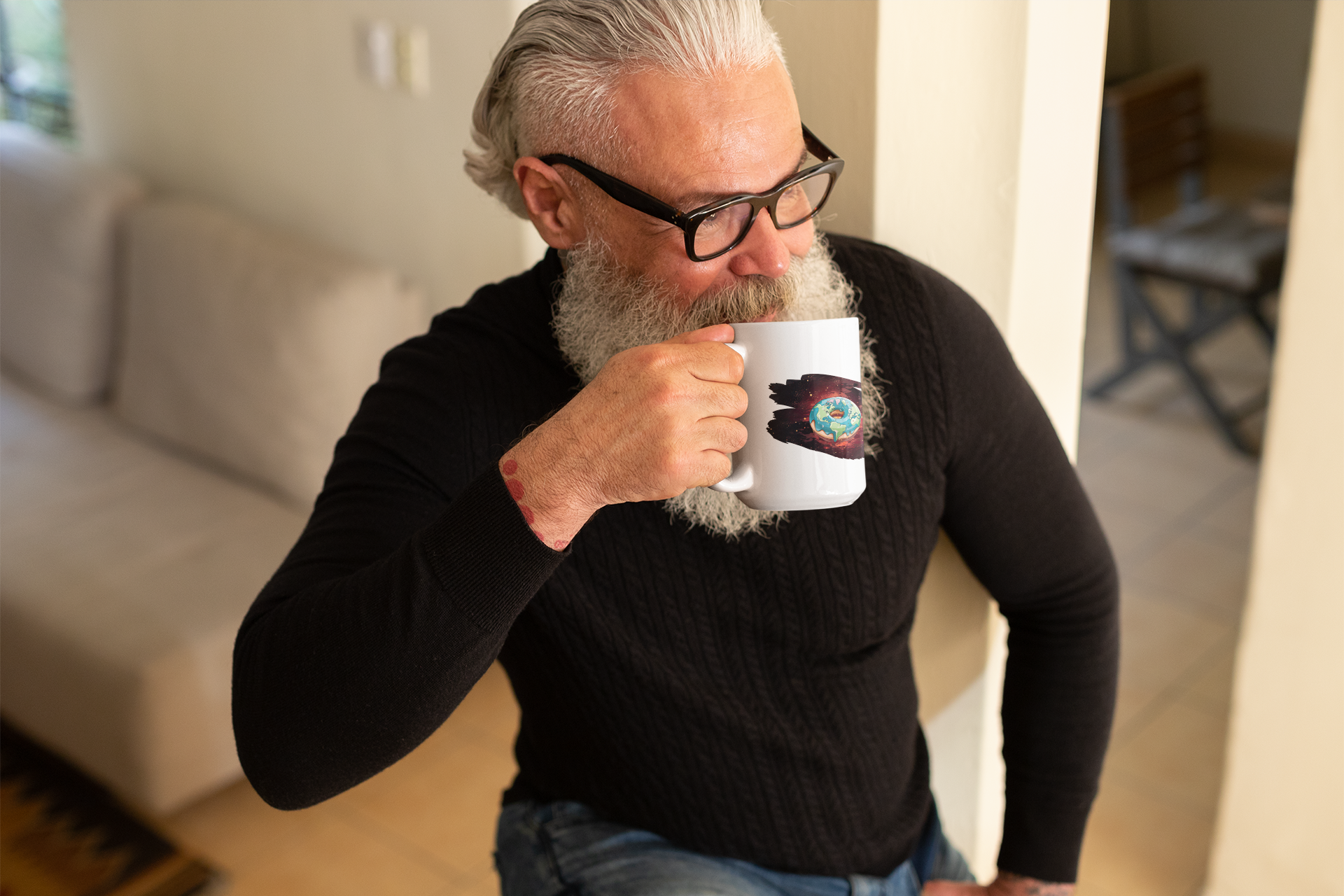 A well-groomed older man looks into the distance and holds a mug with a galaxy donut motif in his hand.